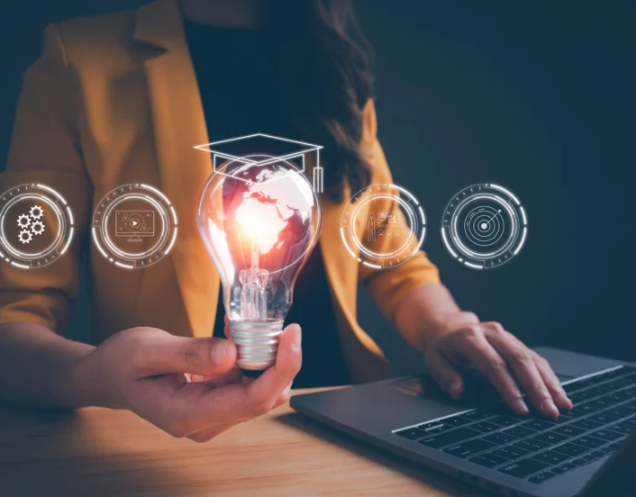 Woman hand holding light bulb with online education training Concept of digital courses to develop new skills, e learning on internet for personal development, learning, graduation, certificate