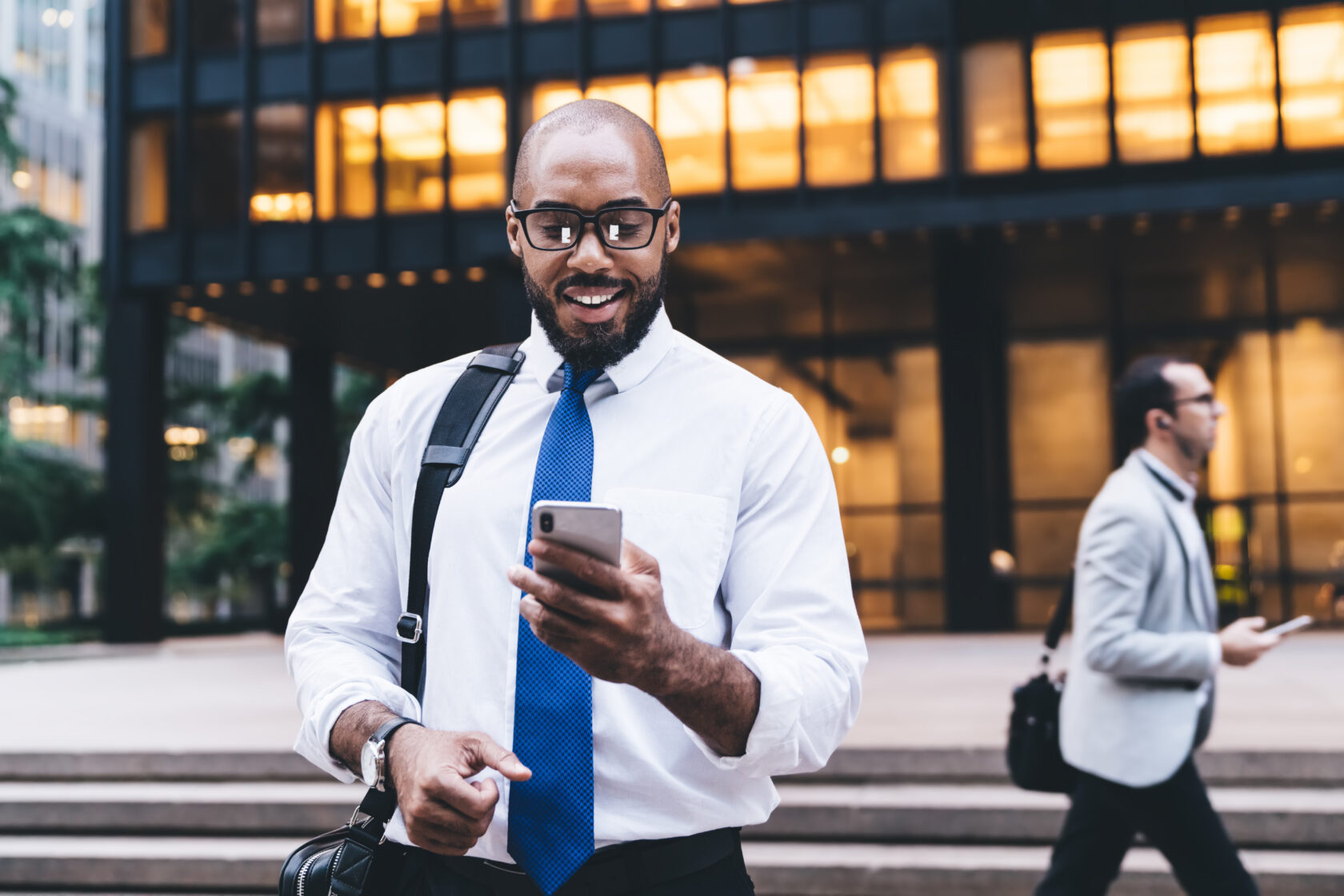 Curious black businessman using smartphone