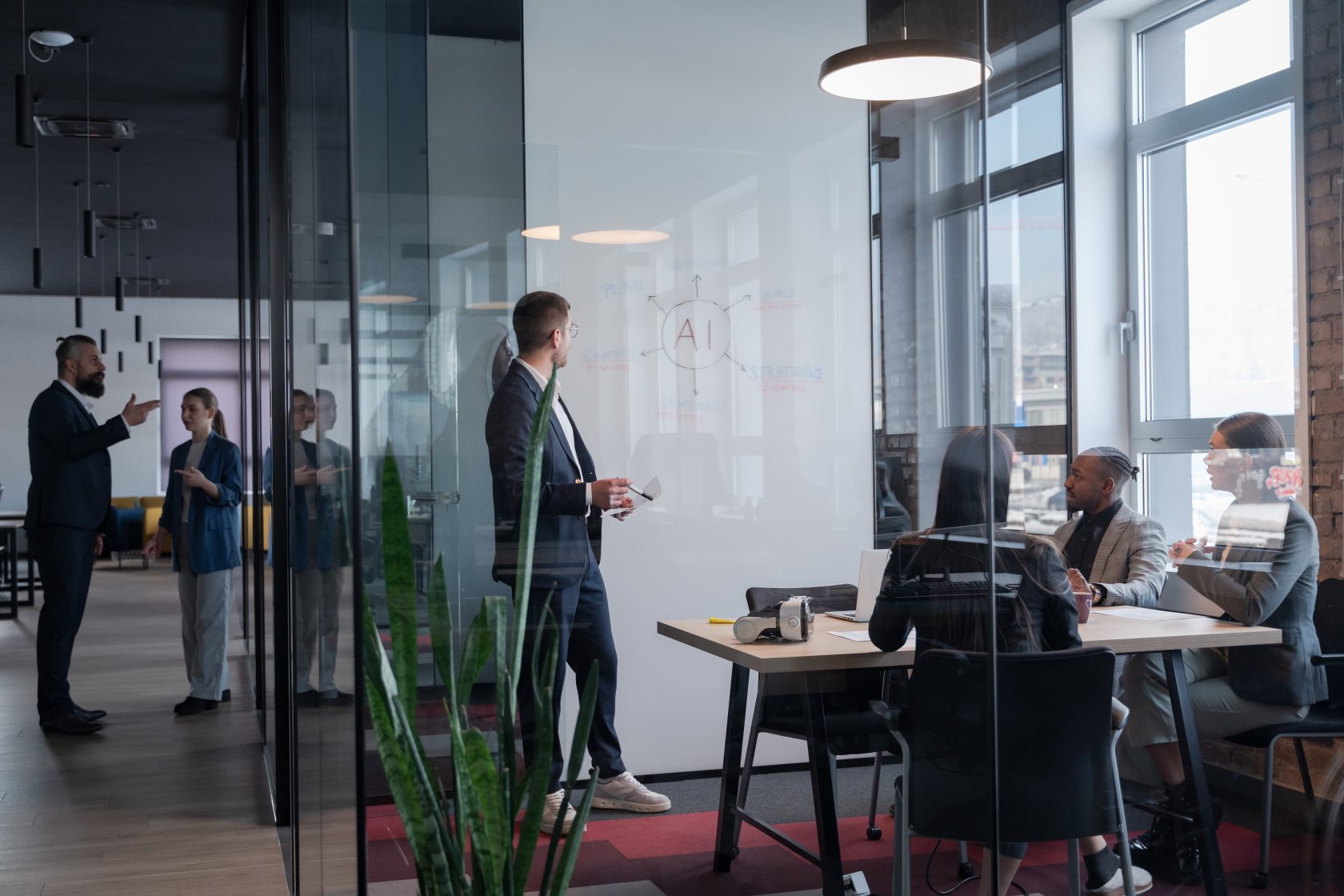 Modern office meeting with diverse professionals discussing artificial intelligence strategy Concept of teamwork, technology, and corporate innovation in a contemporary workspace